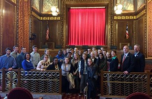 Image of a large group of men and women in the courtroom of the Thomas J. Moyer Ohio Judicial Center.