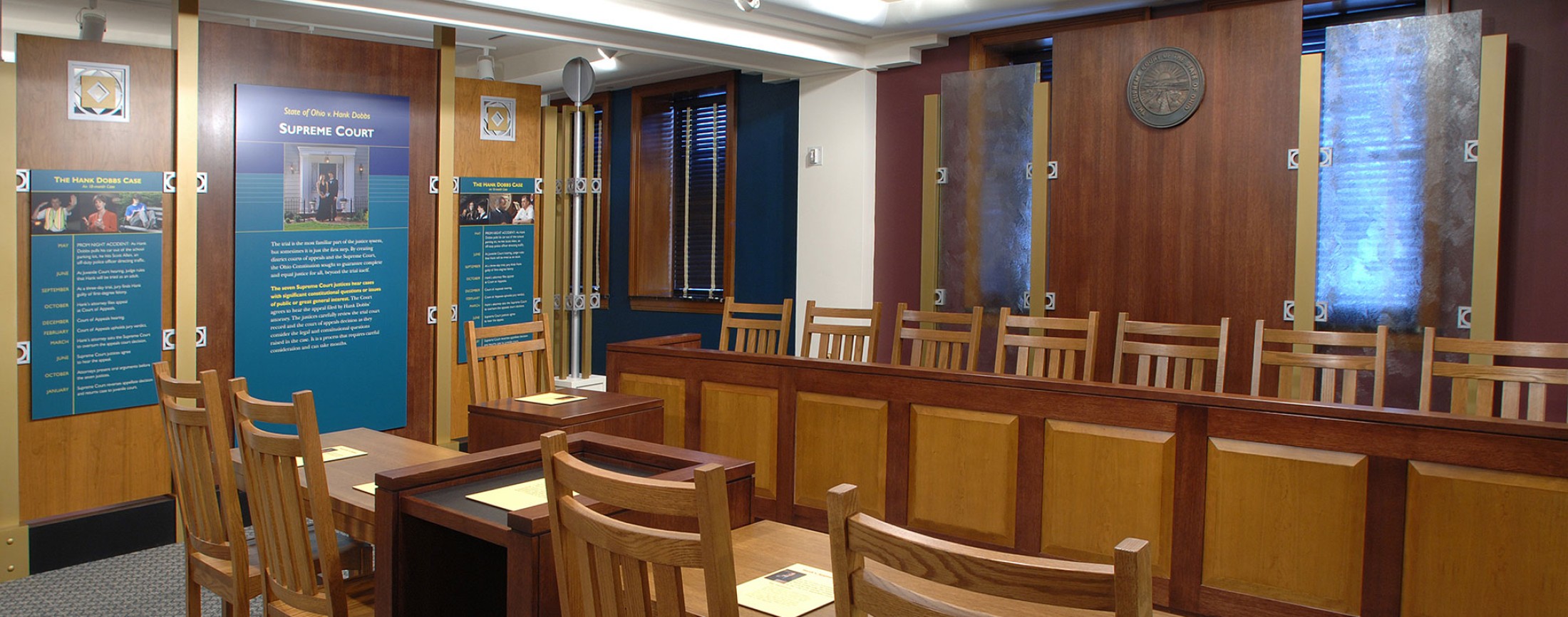 Wooden chairs in a wooden jury box.