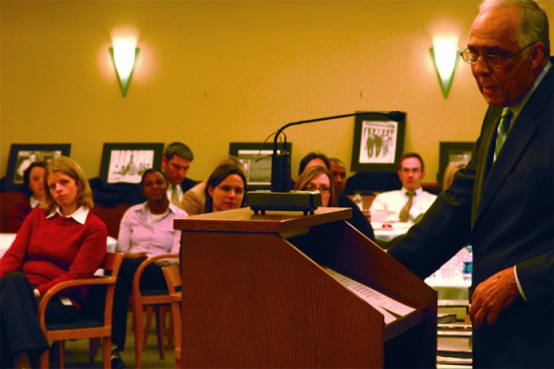 Image of Robert M. Duncan speaking to a group of people from behind a podium